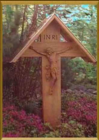Grave cross made of oak with the crucified Jesus